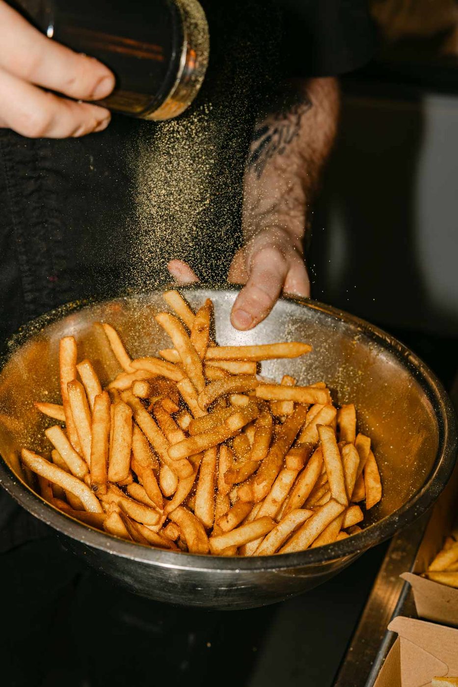 Seasoning fries on the line